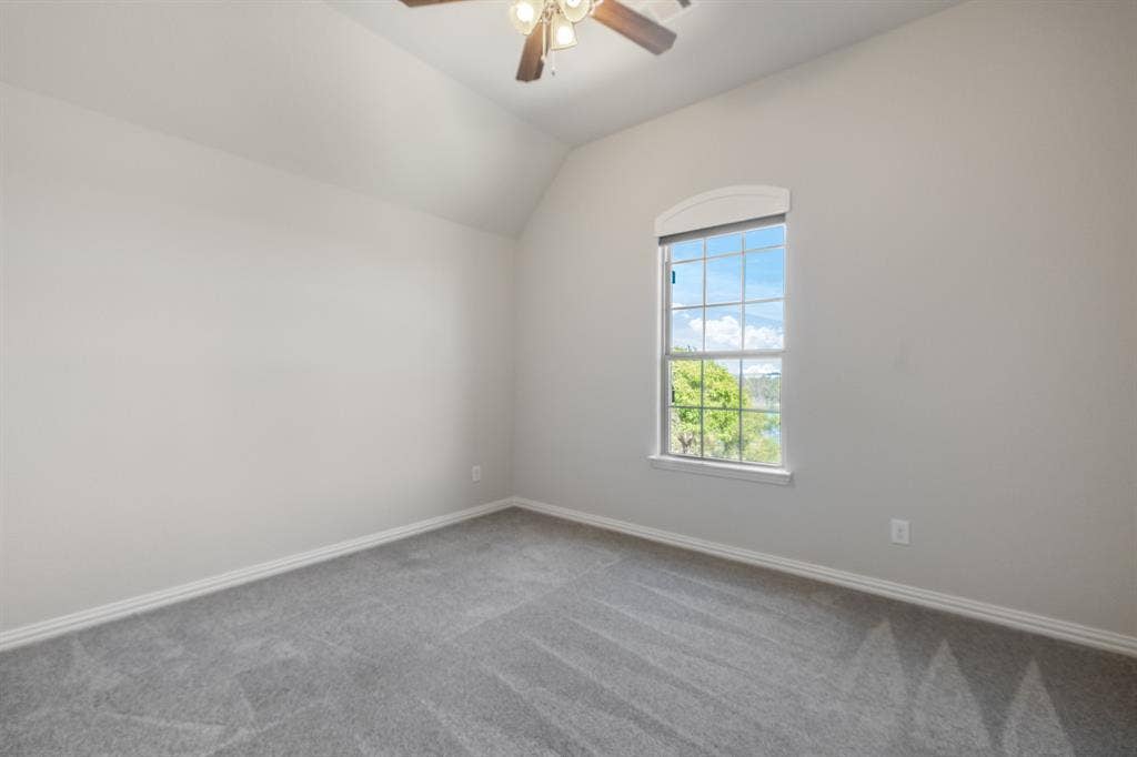 Upstairs fourth bedroom, vaulted ceiling with ceiling fan.