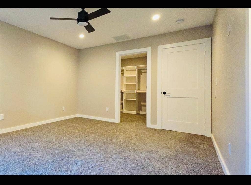 2821 Avenue L, Fort Worth, TX 76105 Spacious room featuring neutral carpeting, a ceiling fan, recessed lighting, and a closet with built-in shelving