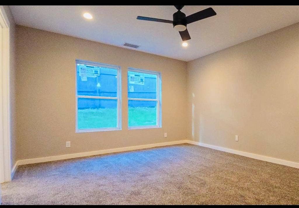 2821 Avenue L, Fort Worth, TX 76105 Plush carpet flooring, recessed ceiling lighting, and a contemporary black ceiling fan