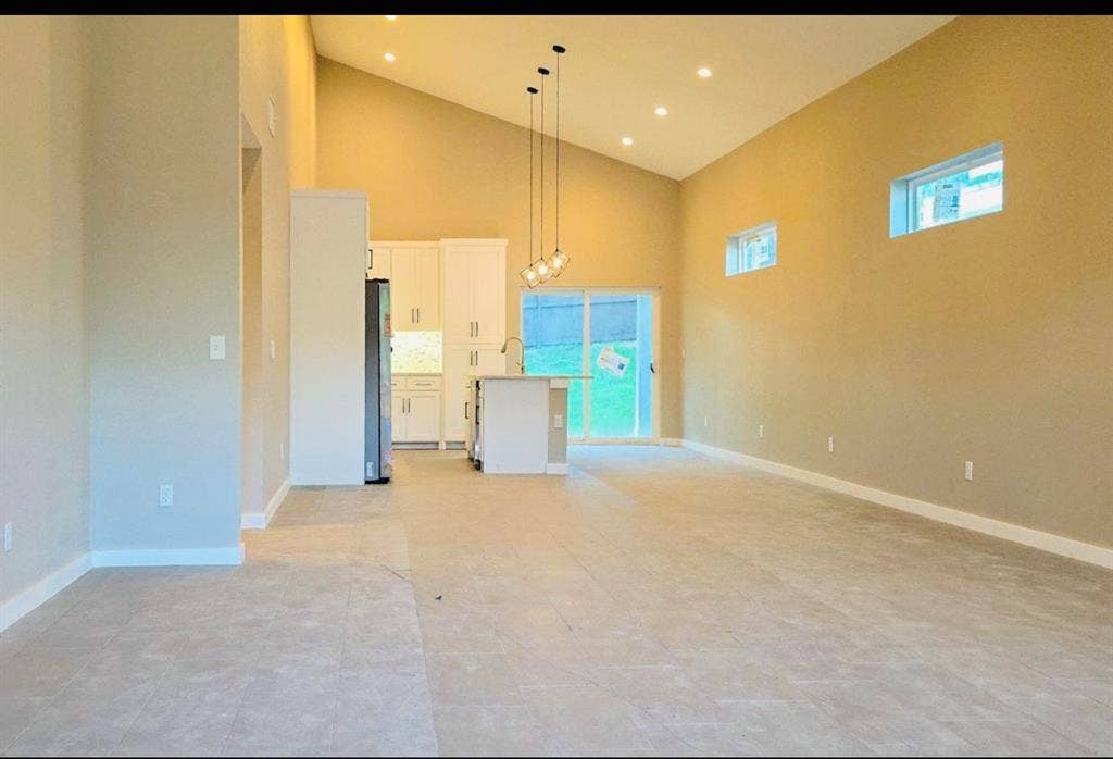 2821 Avenue L, Fort Worth, TX 76105 Vaulted ceiling with recessed lighting and a contemporary pendant fixture