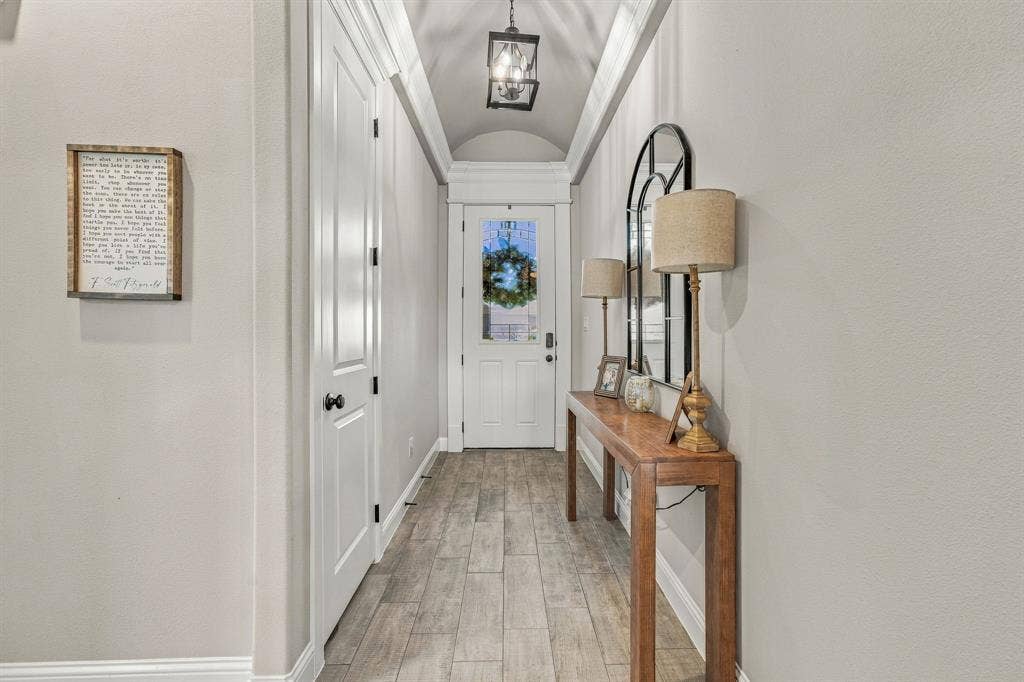 601 Violet Drive, Tolar, TX 76476 Archway ceiling with recessed lighting, wood-finish flooring, and a white paneled door
