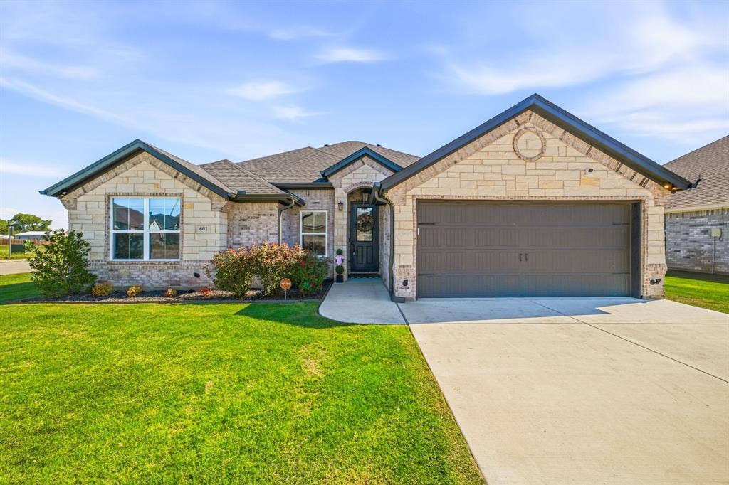 601 Violet Drive, Tolar, TX 76476 Stone and brick exterior with dark trim and a gabled roof