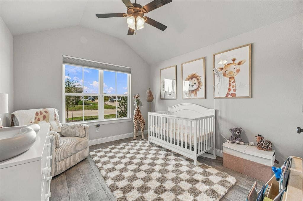 601 Violet Drive, Tolar, TX 76476 Vaulted ceiling featuring a ceiling fan, wood-finish flooring, and a large window