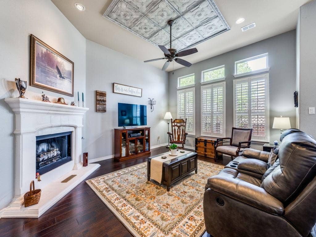 1220 Isabella Lane, Savannah, TX 76227 A cozy fireplace creates the perfect focal point for this warm and inviting living space