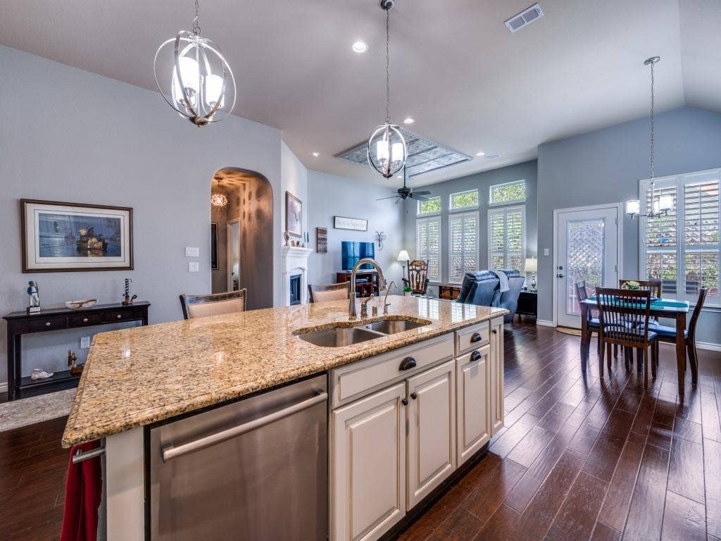 1220 Isabella Lane, Savannah, TX 76227 The kitchen island opens to the living area, creating an easy flow for gathering and everyday living