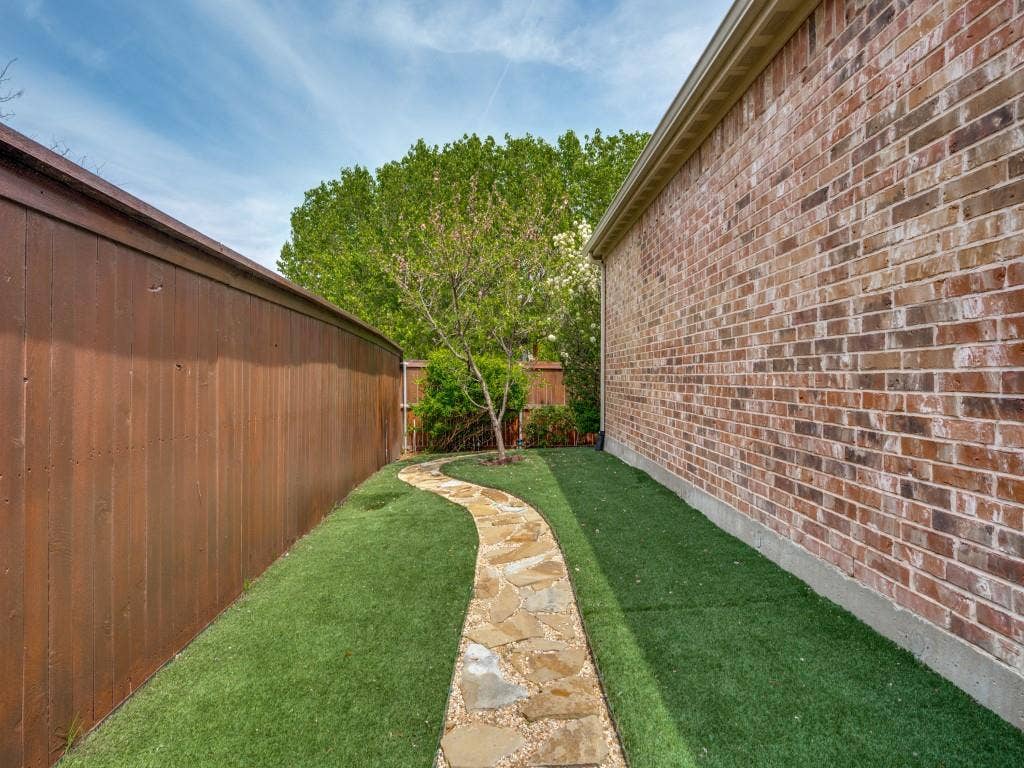 1220 Isabella Lane, Savannah, TX 76227 AstroTurf, perennial landscaping, and a peach tree add beauty without the upkeep