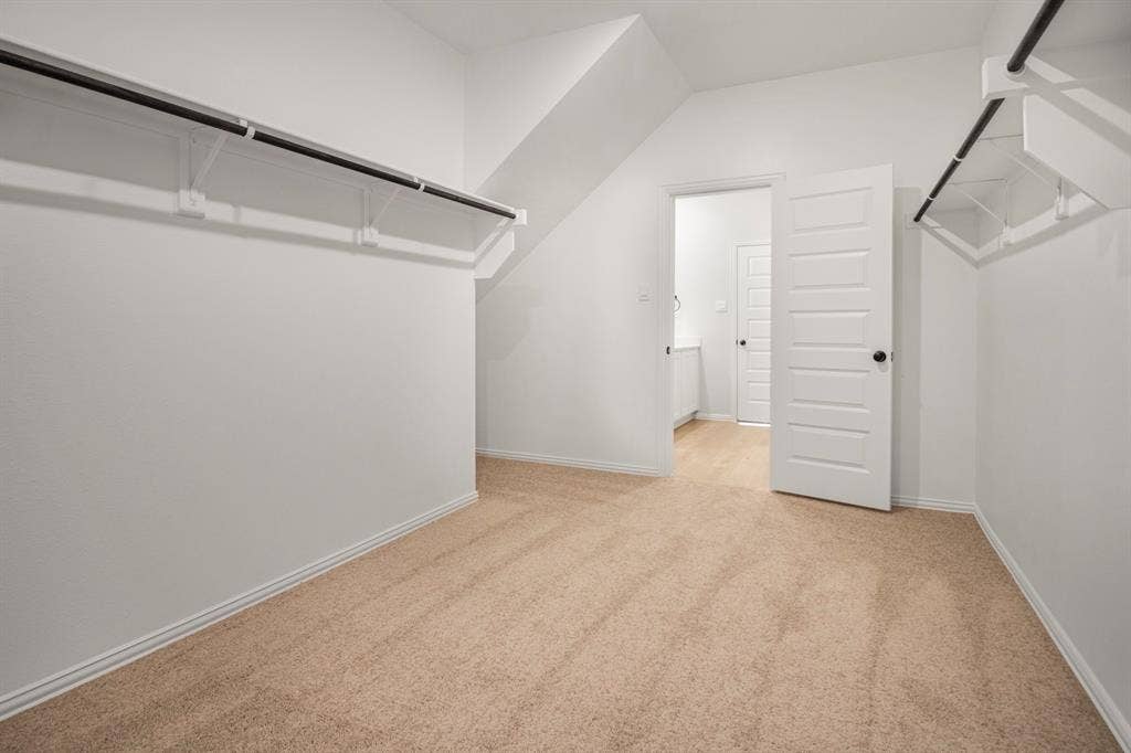 3517 Foxhound Lane, Denton, TX 76208 Light-colored carpeting, white walls, built-in closet shelving, and a paneled interior door with dark hardware