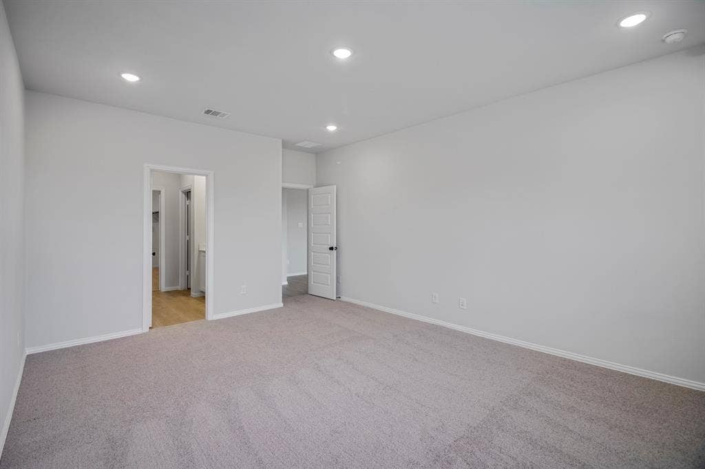 3517 Foxhound Lane, Denton, TX 76208 Recessed ceiling lighting, light gray wall paint, light gray carpet flooring, white trim, and white paneled doors