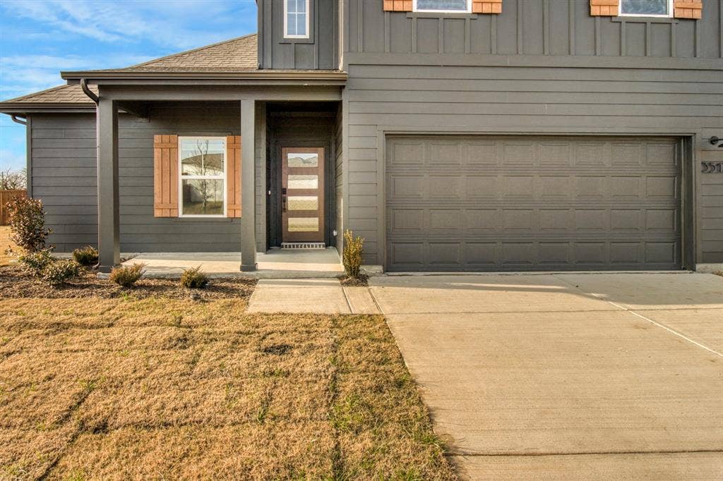 3517 Foxhound Lane, Denton, TX 76208 Dark gray exterior siding with board and batten accents
