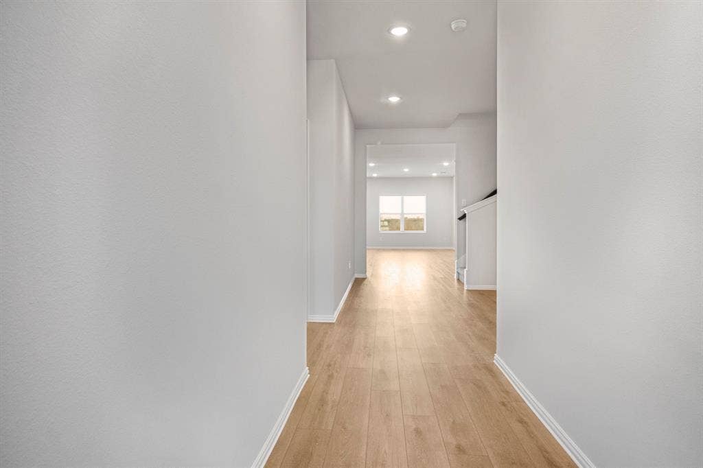 3517 Foxhound Lane, Denton, TX 76208 Hallway with recessed lighting, light wood-finish flooring, white walls, and white trim