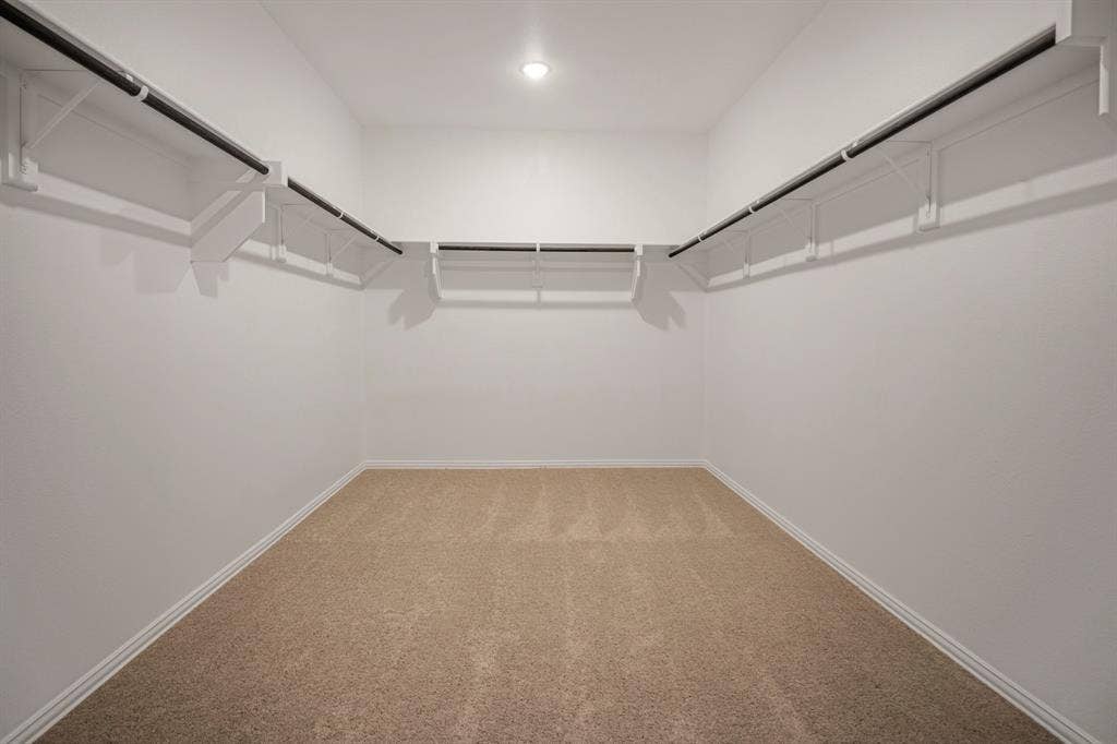 3517 Foxhound Lane, Denton, TX 76208 Expansive walk-in closet featuring built-in shelving, hanging rods, and recessed lighting