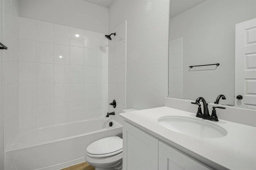 3517 Foxhound Lane, Denton, TX 76208 White tile tub and shower combination with matte black fixtures