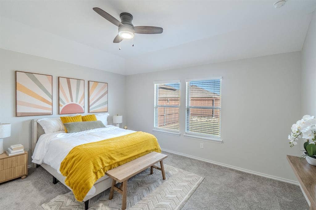 1842 Shady Elm Drive, Lancaster, TX 75146 Tray ceiling with a ceiling fan, two windows with blinds, and light-toned wall-to-wall carpeting