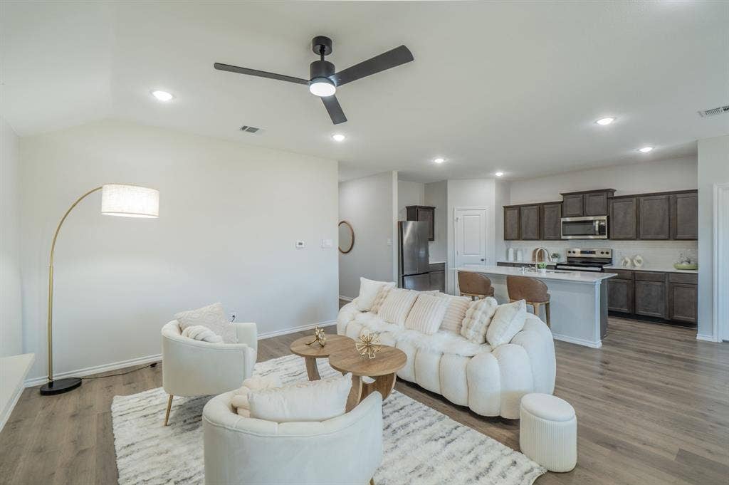1842 Shady Elm Drive, Lancaster, TX 75146 Wood-finish flooring throughout, recessed lighting, ceiling fan, and kitchen featuring dark cabinetry, stainless steel appliances, and a central island