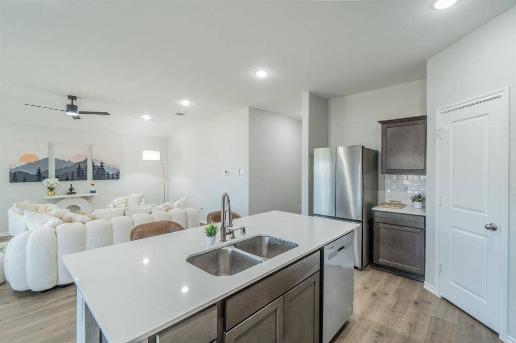 1842 Shady Elm Drive, Lancaster, TX 75146 Open-concept living area with wood-finish flooring, recessed lighting, and a contemporary ceiling fan