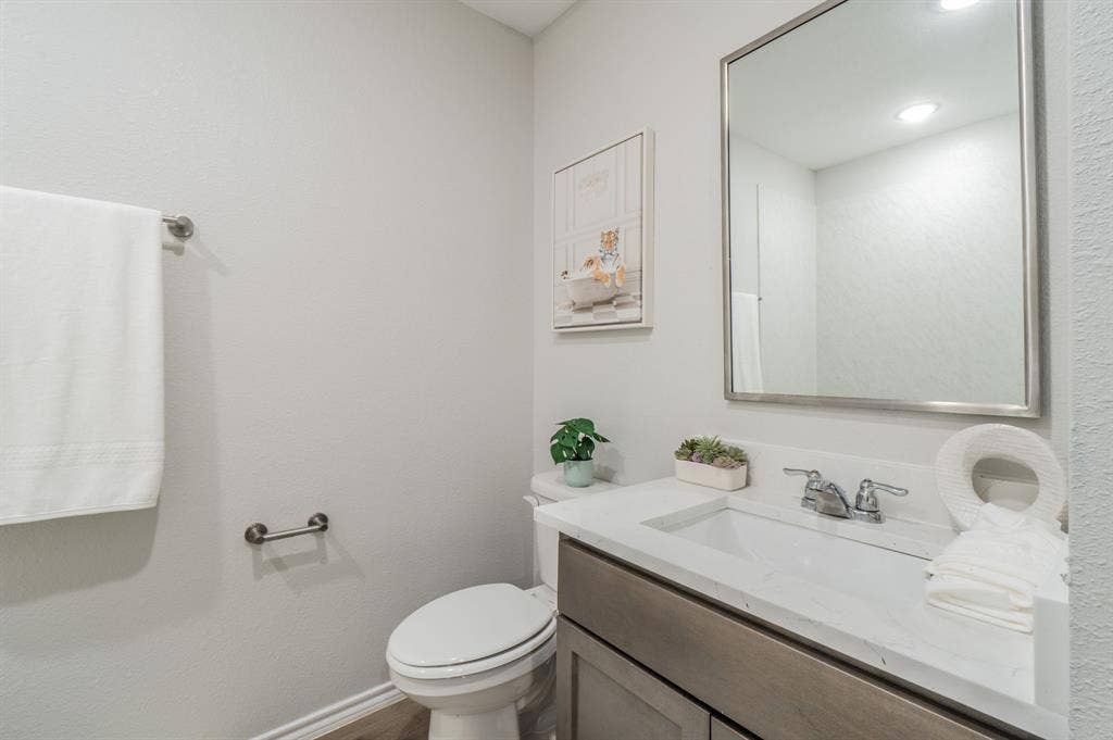 1842 Shady Elm Drive, Lancaster, TX 75146 Vanity with a rectangular undermount sink, dual-handle faucet, and reflective framed mirror