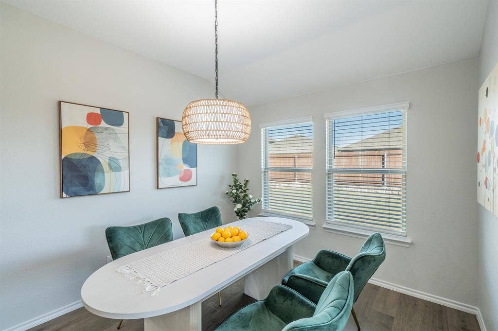 1842 Shady Elm Drive, Lancaster, TX 75146 Two windows with horizontal blinds, wood-finish flooring, and a woven pendant light fixture