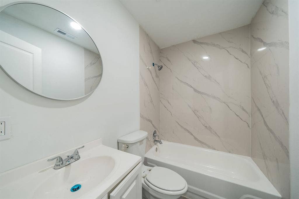 White vanity with an integrated sink and chrome faucet
