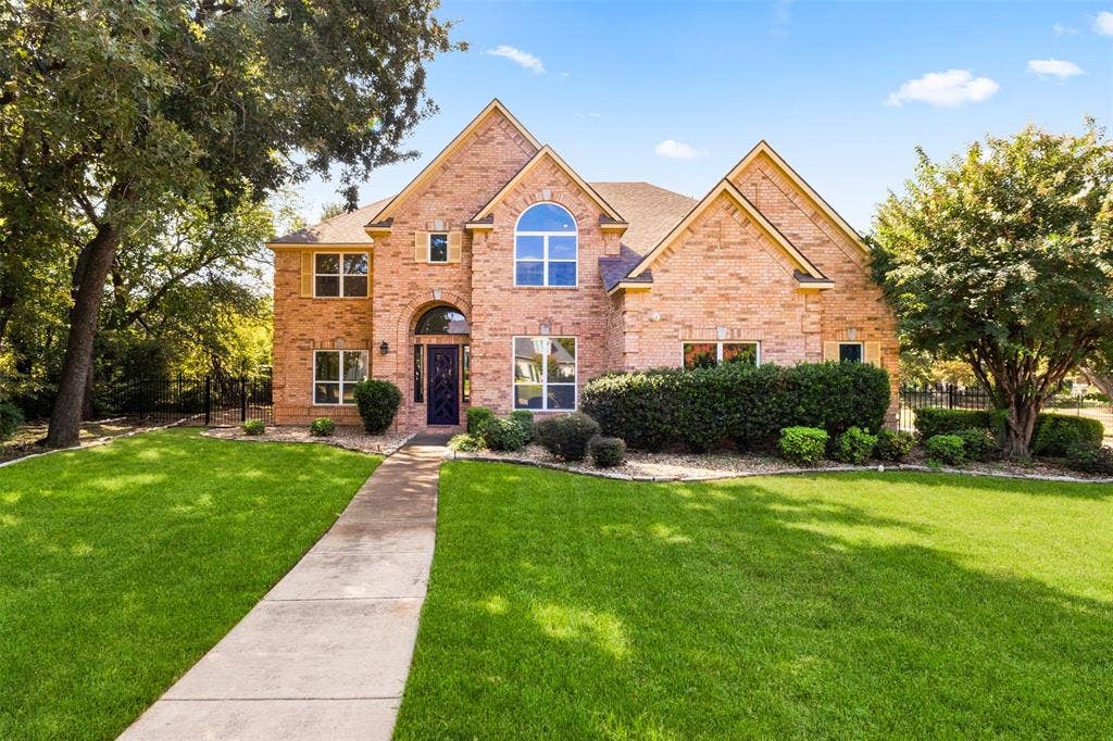 Brick exterior with arched entry and transom window