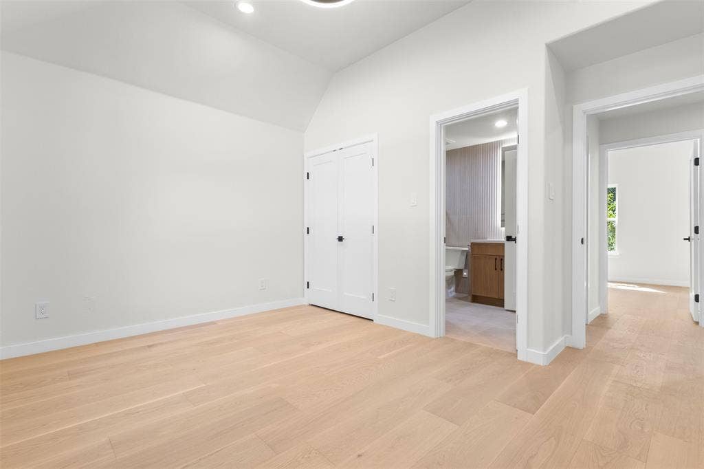 Light wood-finish flooring with white baseboards