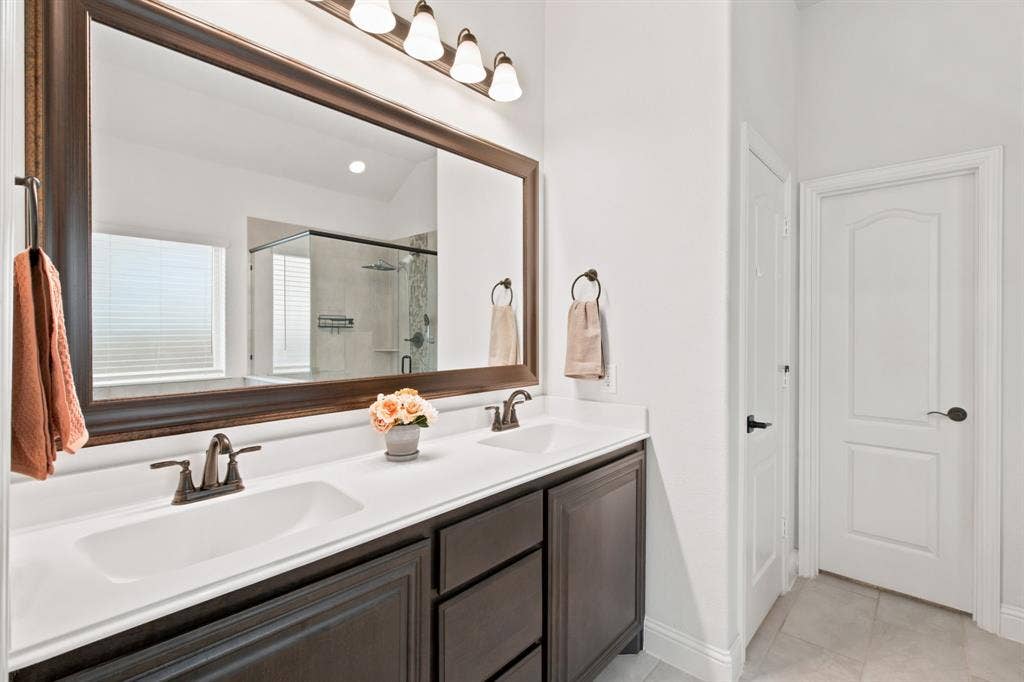 1218 Misty Ridge Drive, Justin, TX 76247 Dual vanity with dark wood-finish cabinetry and white countertops
