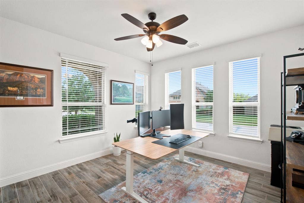 1218 Misty Ridge Drive, Justin, TX 76247 Room featuring wood-look tile flooring, multiple windows with blinds, a ceiling fan, and white painted walls