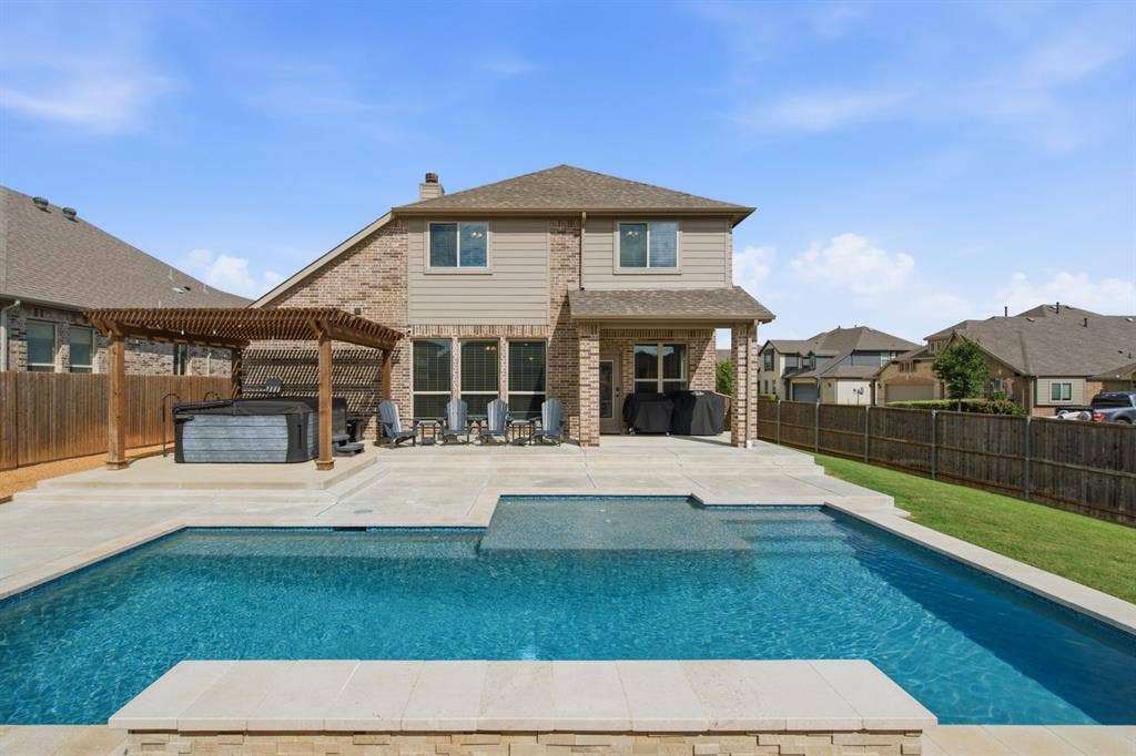 1218 Misty Ridge Drive, Justin, TX 76247 Private backyard featuring an in-ground pool, freestanding spa, and pergola