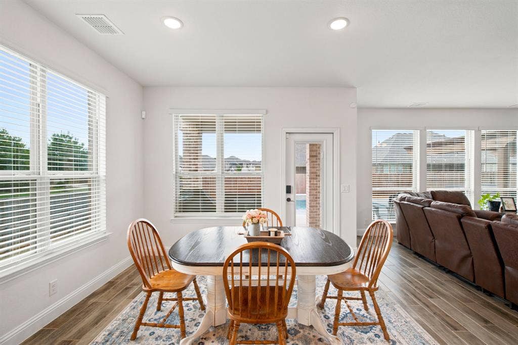 1218 Misty Ridge Drive, Justin, TX 76247 Recessed lighting, multiple windows with blinds, white trim, wood-look tile flooring, and a white door with a clear glass panel