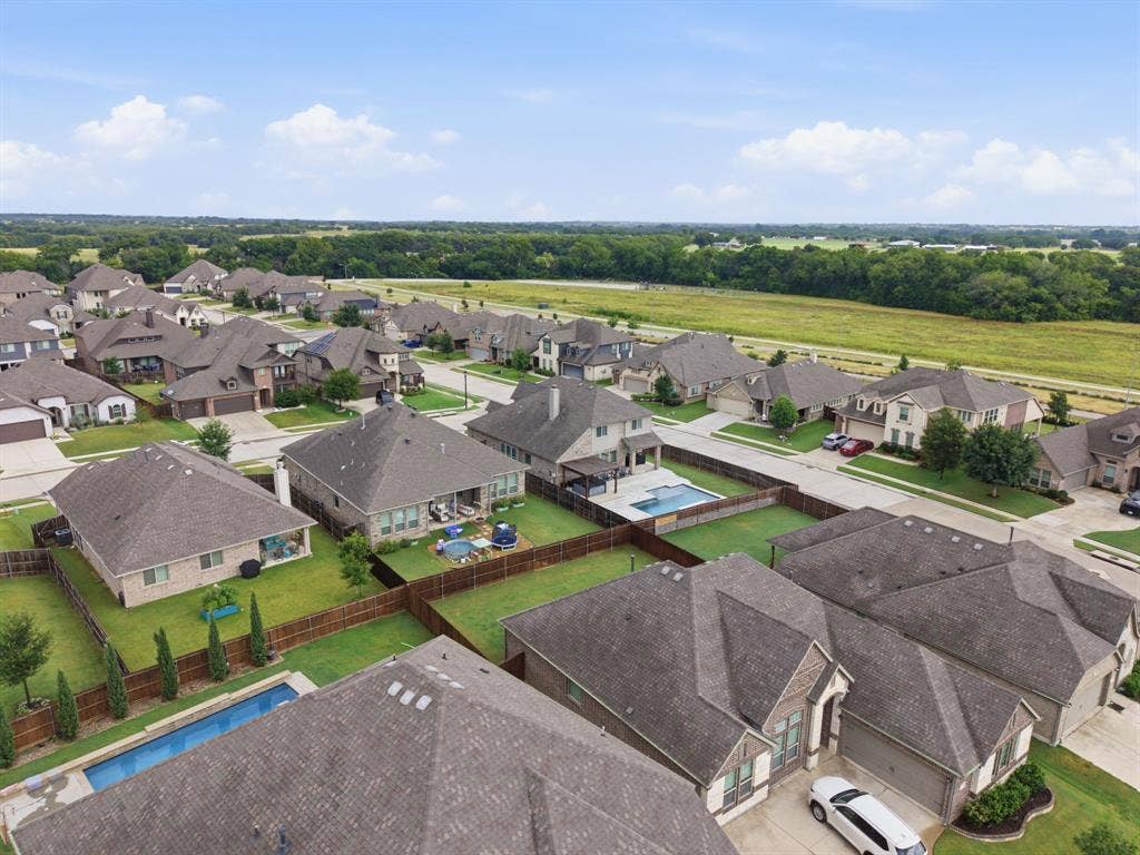 1218 Misty Ridge Drive, Justin, TX 76247 Residential neighborhood with diverse architectural styles, featuring private pools and expansive green spaces