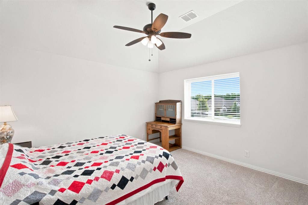 1218 Misty Ridge Drive, Justin, TX 76247 White walls, light-colored carpeting, and a ceiling fan with light fixture