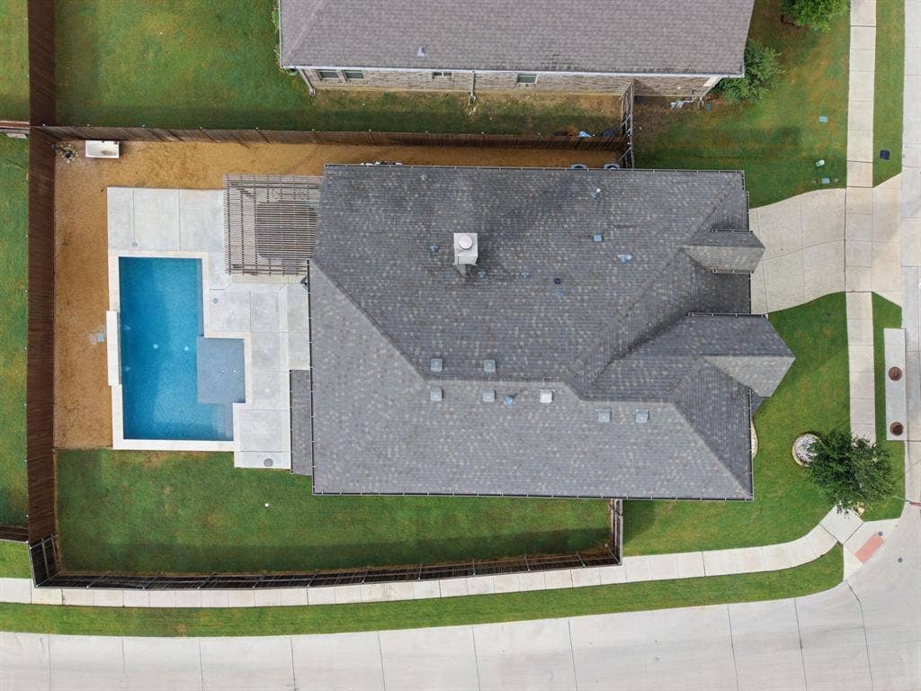 1218 Misty Ridge Drive, Justin, TX 76247 Asphalt shingle roof, concrete patio, in-ground swimming pool, and wood privacy fencing