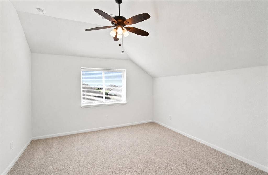 1218 Misty Ridge Drive, Justin, TX 76247 Vaulted ceiling with a ceiling fan, window with blinds, and neutral carpeting