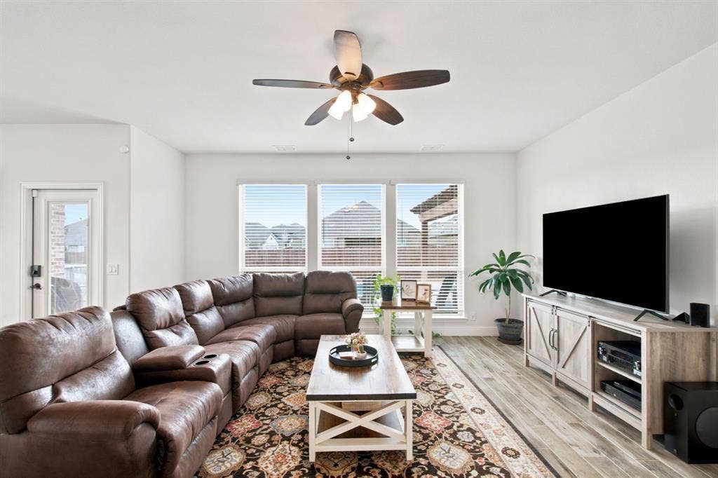 1218 Misty Ridge Drive, Justin, TX 76247 Wood-look tile flooring, white walls, and a ceiling fan with integrated lighting