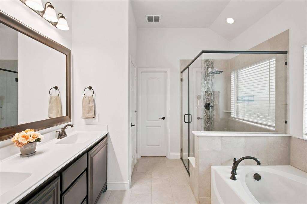 1218 Misty Ridge Drive, Justin, TX 76247 Dual vanity with rectangular sinks, a glass-enclosed shower, a built-in bathtub, and tile flooring