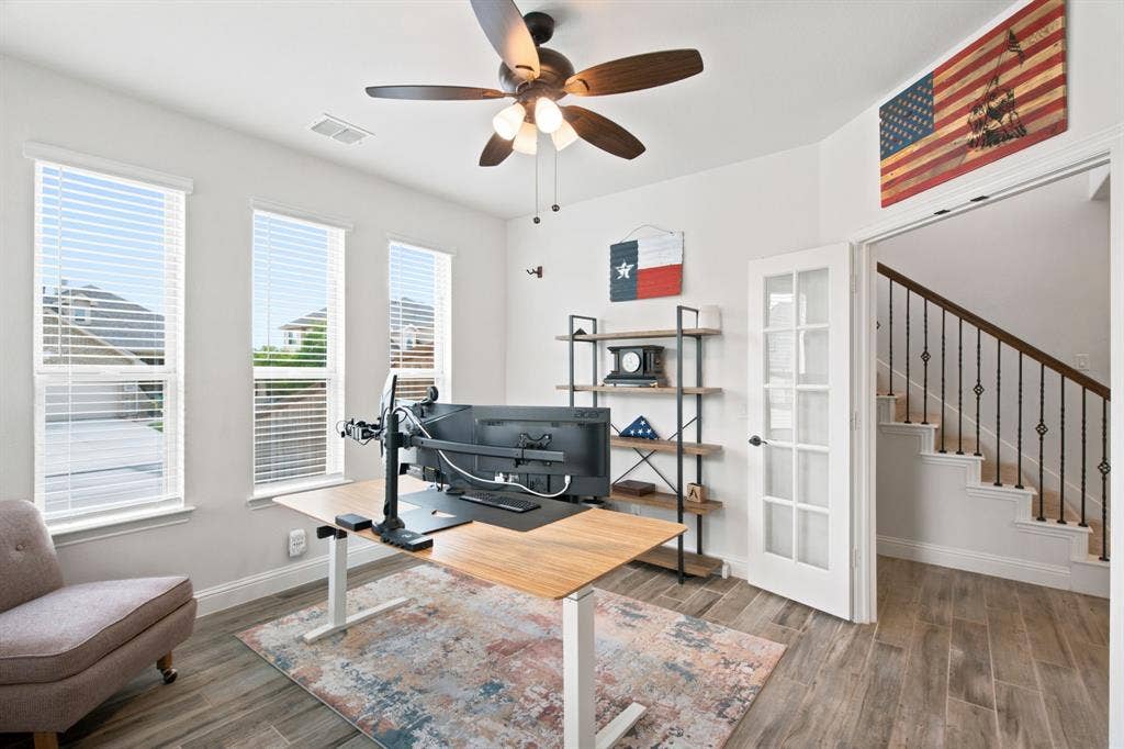 1218 Misty Ridge Drive, Justin, TX 76247 Room featuring three large windows, a ceiling fan with integrated lighting, wood-look tile flooring, and French doors