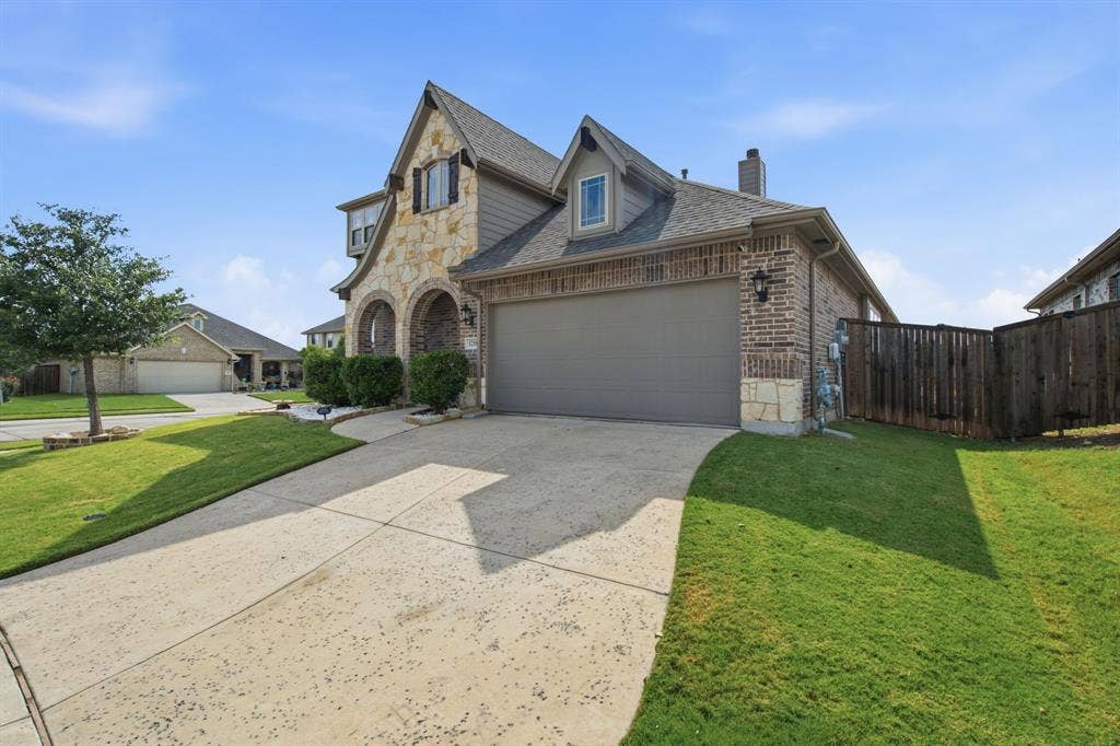 1218 Misty Ridge Drive, Justin, TX 76247 Stone and brick exterior with arched entryway