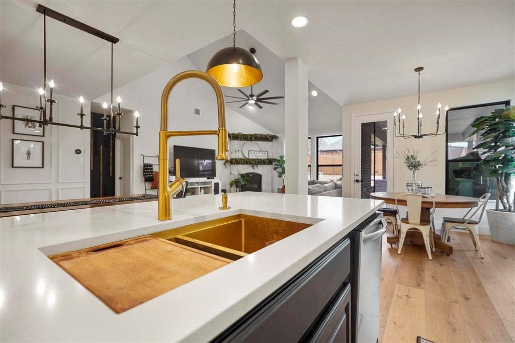 1506 Carnation Street, Celina, TX 75078 White countertop island with integrated gold-tone sink and modern brass faucet
