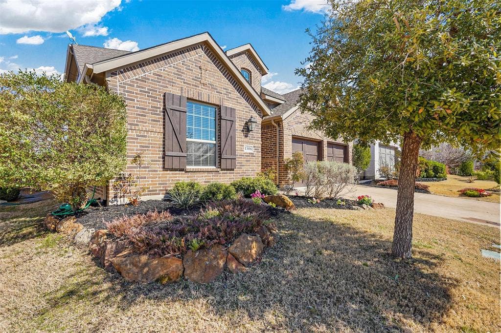1506 Carnation Street, Celina, TX 75078 Brick exterior with wood-tone shutters
