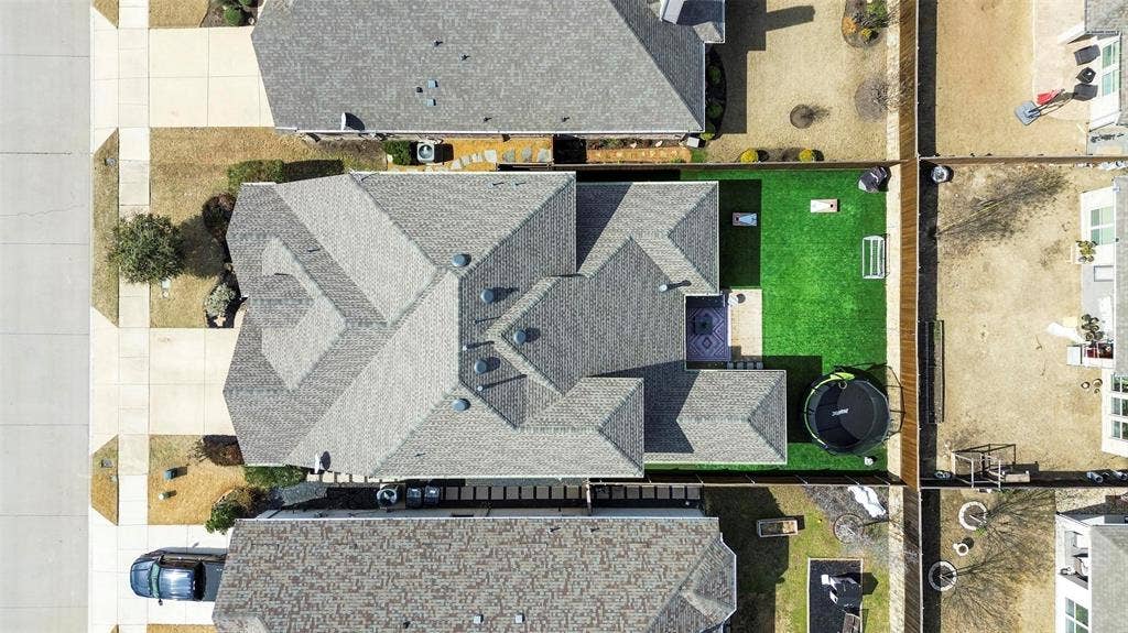 1506 Carnation Street, Celina, TX 75078 Expansive backyard featuring a manicured lawn, paved patio, and privacy fencing