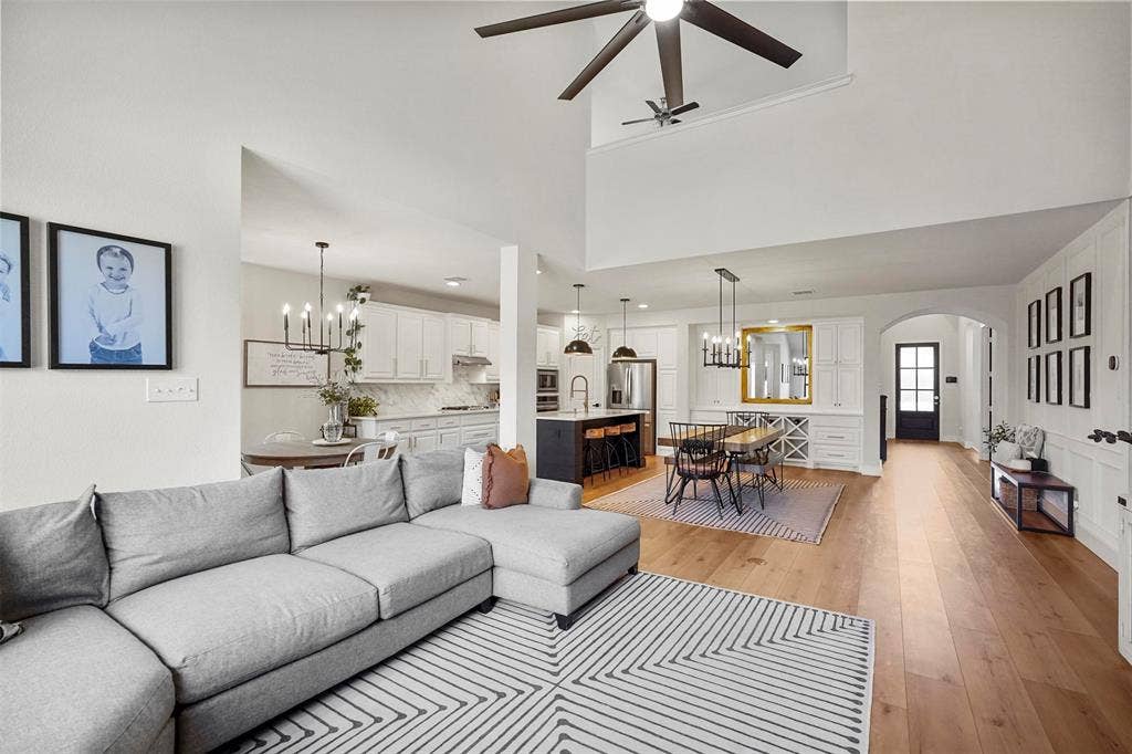 1506 Carnation Street, Celina, TX 75078 High ceilings, wood-finish flooring, white paneled accent wall, arched doorway, and built-in cabinetry