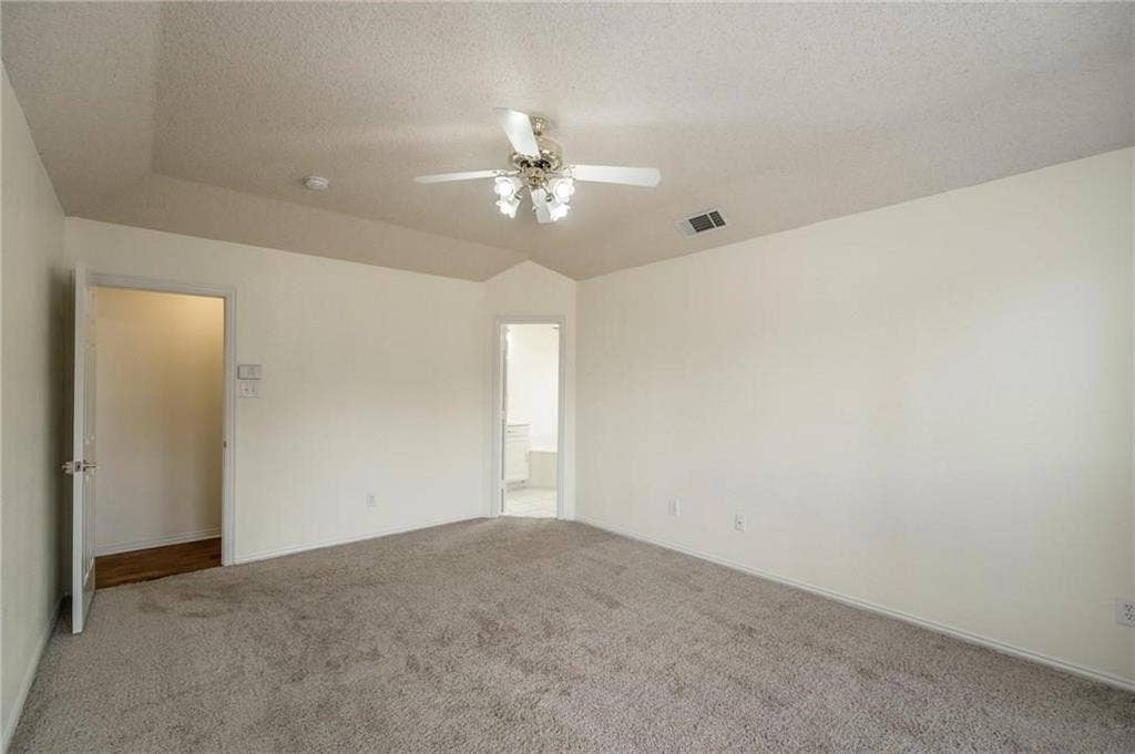 5000 Pointclear Court, Arlington, TX 76017 Vaulted ceiling with ceiling fan and light fixture, carpeted flooring, and neutral wall tones