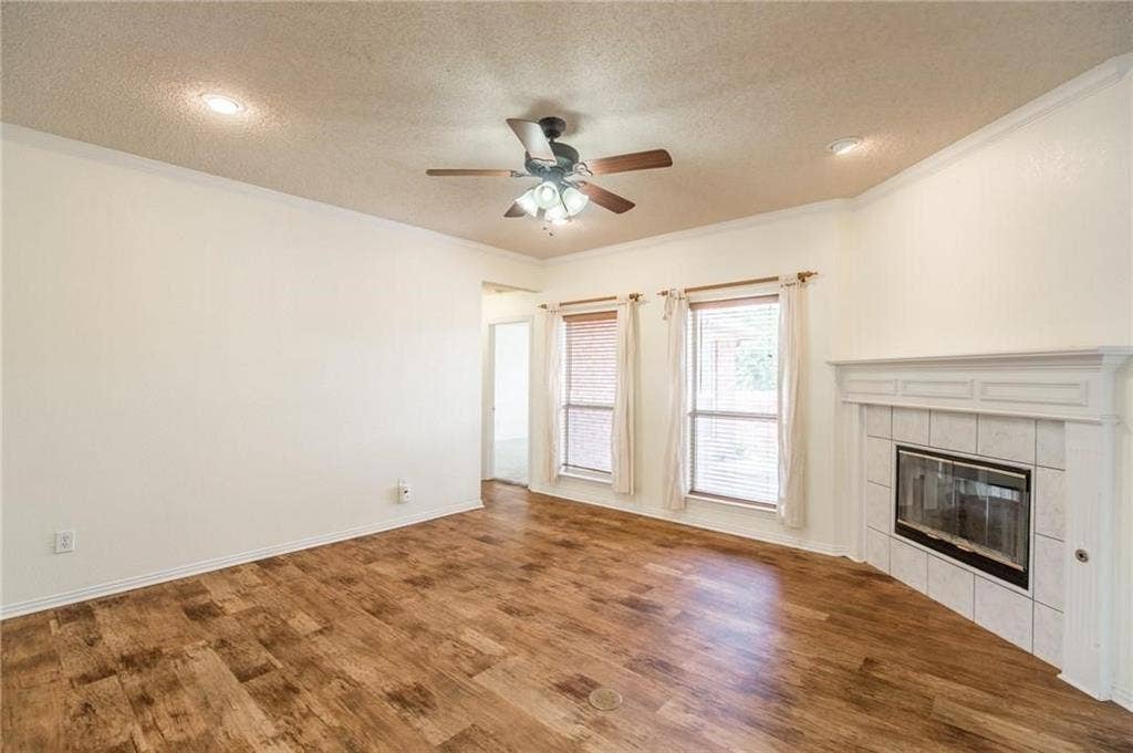 5000 Pointclear Court, Arlington, TX 76017 Wood-finish flooring, recessed lighting, ceiling fan, white trim, and a tiled fireplace