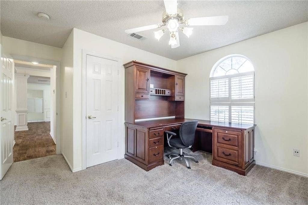 5000 Pointclear Court, Arlington, TX 76017 Arched window with plantation shutters, ceiling fan with integrated lighting, and neutral wall tones