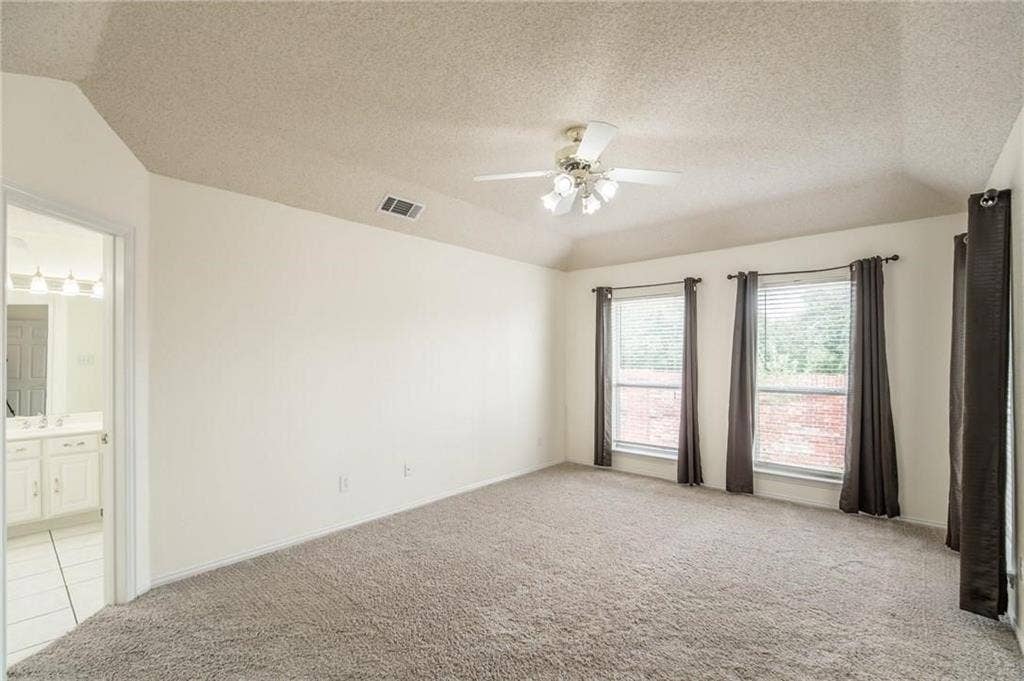 5000 Pointclear Court, Arlington, TX 76017 Carpeted room with a ceiling fan and three windows