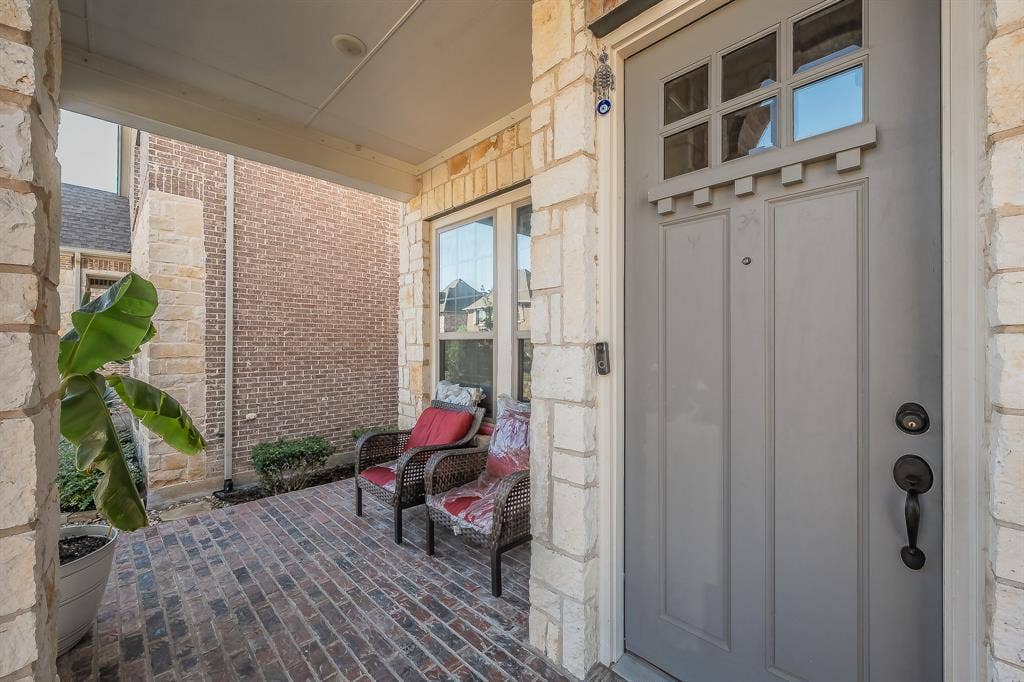 Inviting covered front porch with craftsman-style front door
