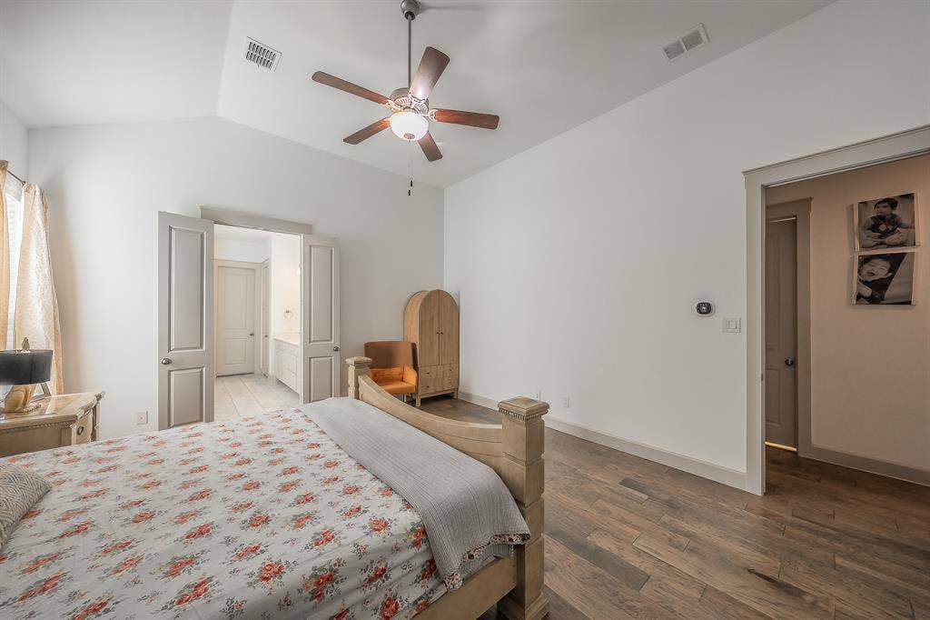 Spacious first floor primary bedroom features 2 separate walk-in closets and an ensuite bathroom with soaking tub and shower