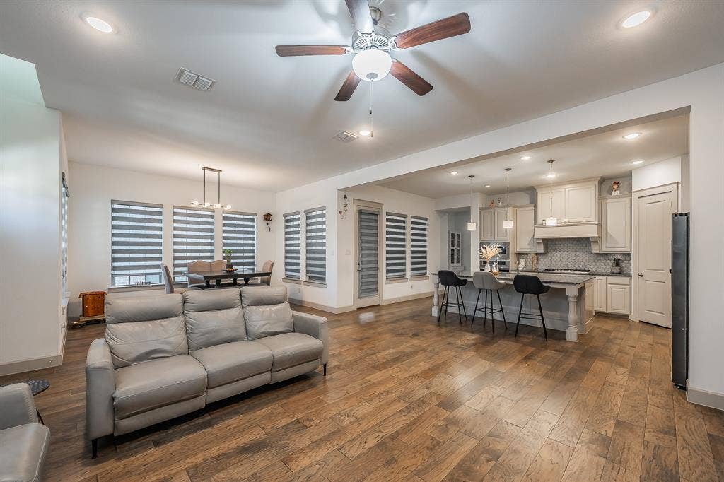 Living room is connected to a dedicated dining area spacious enough for an 8' table