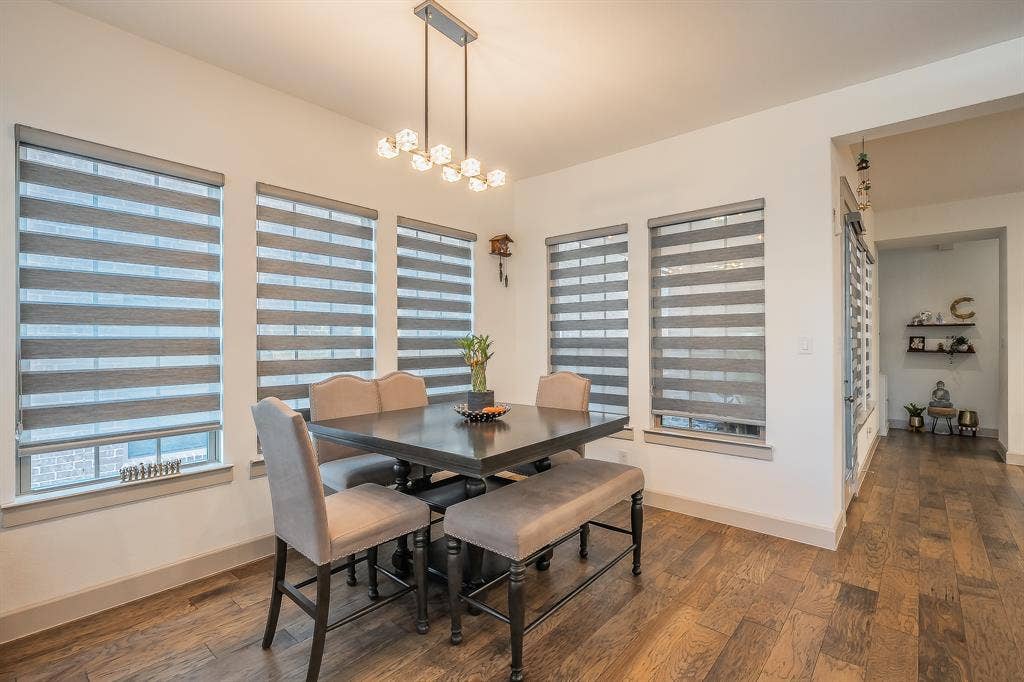 Large dining area surrounded by windows with custom shades