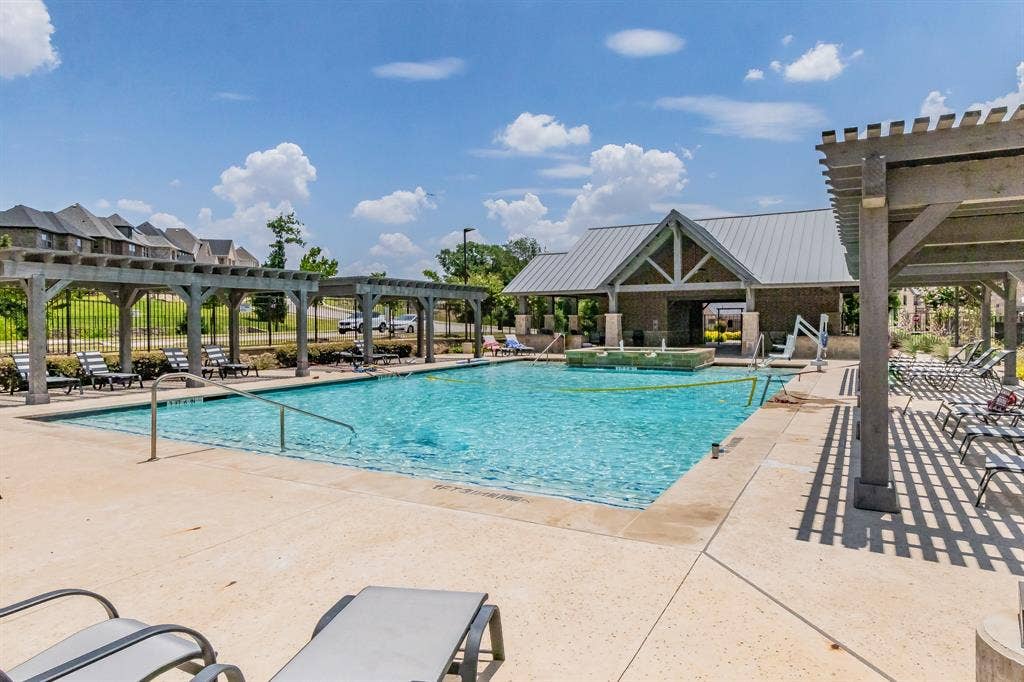 Expansive community pool with year-round grilling area and restrooms