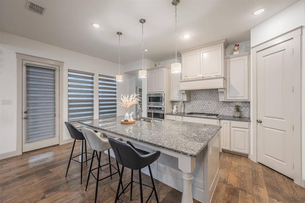 Kitchen featuring beautiful tile backsplash, large pots and pans drawers, and a walk-in pantry